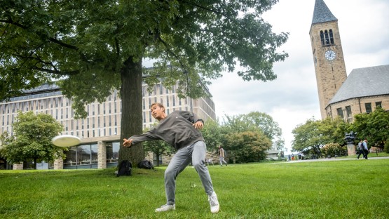 Student playing frisbee on Arts Quad