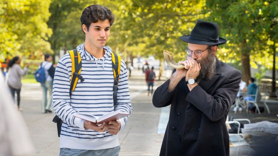Rabbi Dovid Birk plays the shofar for Rosh Hashanah on Ho Plaza.