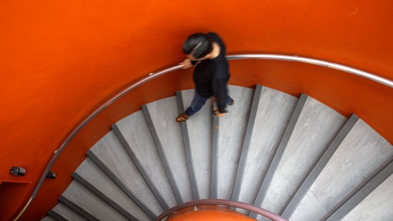 A visitor descends the staircase into the Cocktail Lounge in Uris Library.