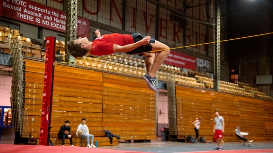 A high jumper practices in Barton Hall.