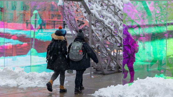 Students on a snowy walk to class near the College of Human Ecology through the PolyForm Art installation.