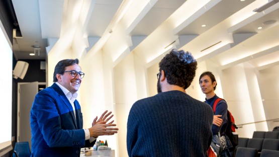 Dr. Dario Gil, left, of IBM speaks with students in Gates Hall during a visit to campus.
