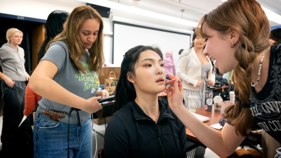student model gets their makeup and hair done
