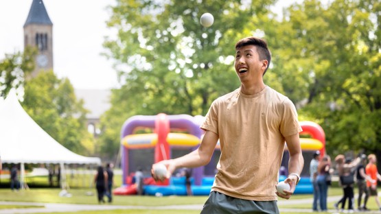 A student juggles during the Senior Days Carnival on the Arts Quad.