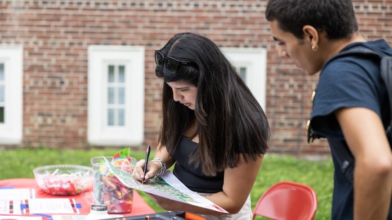 Two people examine a campus map. 