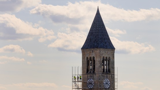 Workers erect scaffolding around McGraw Tower in preparation for maintenence work.