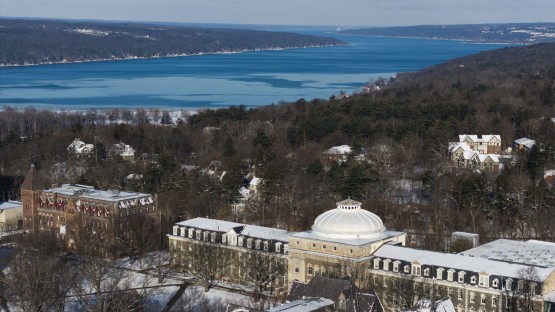 Sibley Hall is seen on a snowy morning with Cayuga Lake in the background.