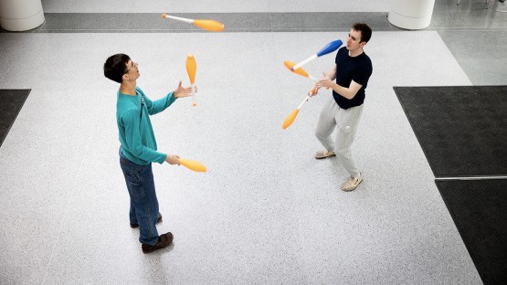 Members of the Cornell Juggling Club toss clubs together during a regular meeting in Physical Sciences Building.