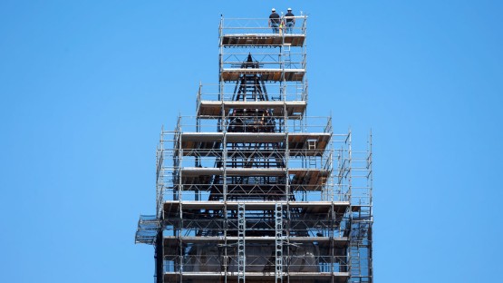 Workers continue with the roof removal from McGraw Tower.