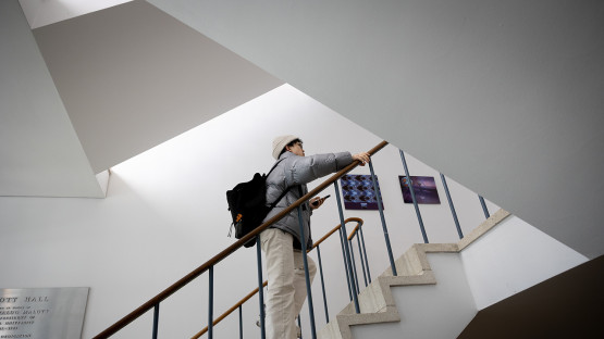 A student climbs the stairs of Malott Hall.