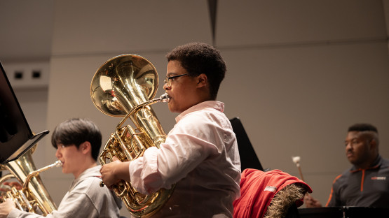 Members of Cornell Wind Symphony rehearse with Film composer Michael Abels in Bailey Hall.