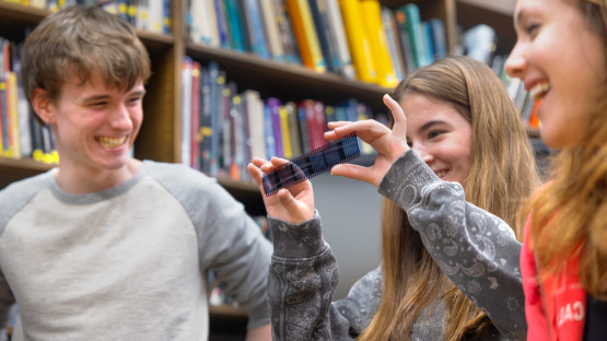 Students from New Visions hold strips of film at the Spacecraft Planetary Image Facility
