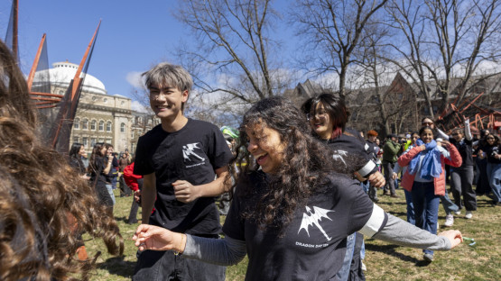Students running around the dragon. 