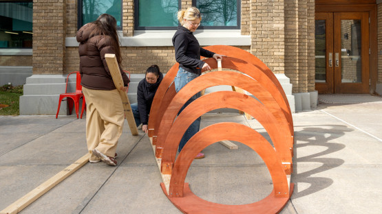 Students work outside of Rand Hall.