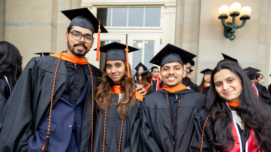 Students posing in front of Goldwin Smith Hall. 