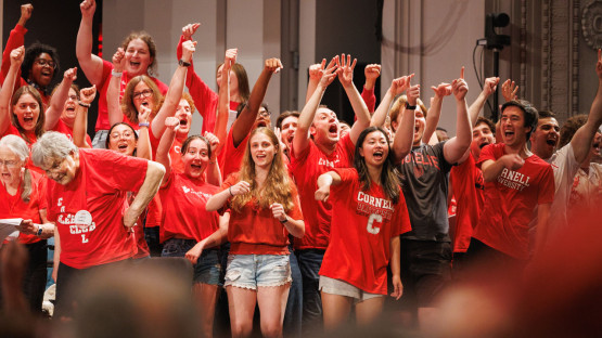 Reunion 2026 attendees raise their hands in celebration