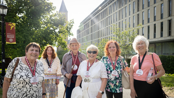 Reunion 2026 attendees stand outside near McGraw Tower