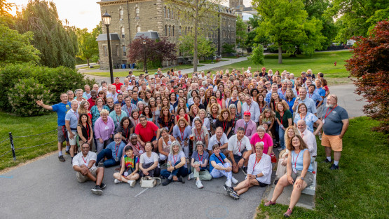 A large group of reunion attendees pose outside