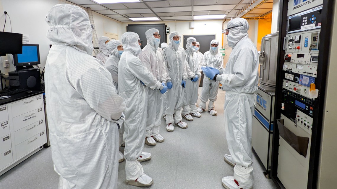 New Visions students in cleanroom suits