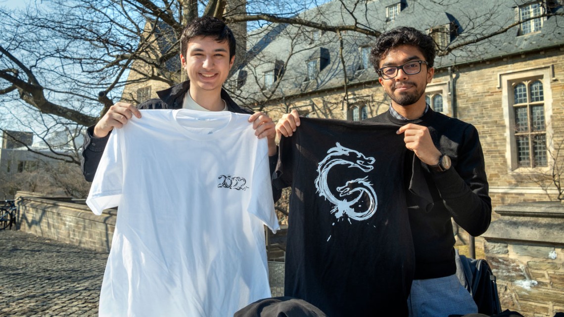 Jose Ortega, left, and Raihaan Bose hold Dragon Day 2022 T-shirts.