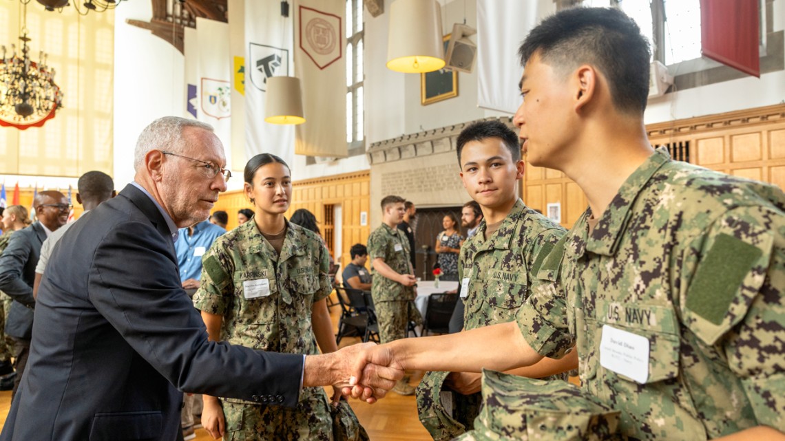 Provost Mike Kotlikoff greets members of military