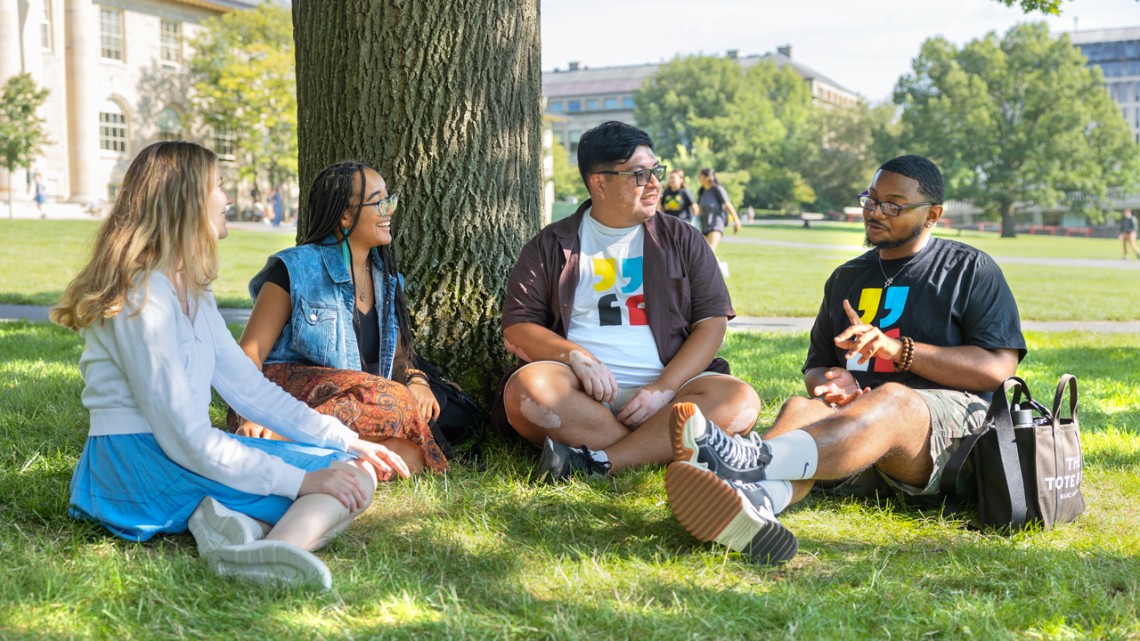 Students have a discussion on campus.