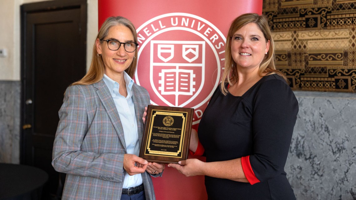 Susan Riley presents Caroline Williams ’01 with the Cornell New York State Hometown Alumni Award..