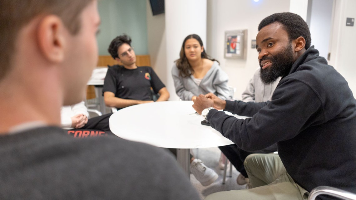 Dr. Kelechi Umoga ’15, co-founder of Crossroads, meets with the current team of student-entrepreneurs, including new co-CEOs Tyler Senzon ’26 and Joy Xu ’25.