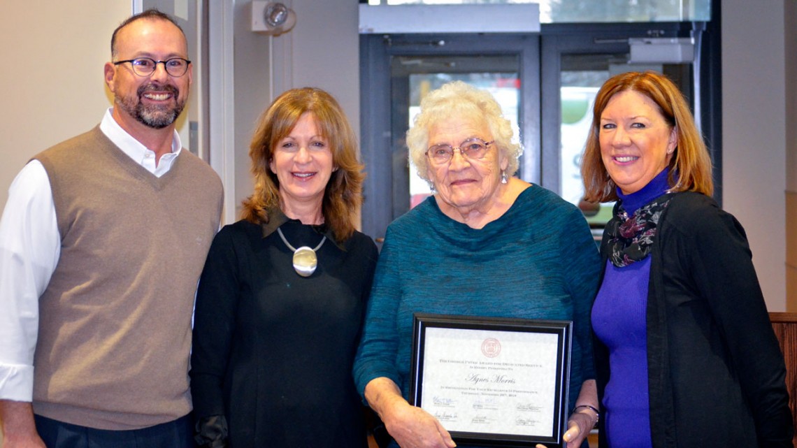 From left: Craig Wiggers, Mary Opperman and (at right) Joanne DeStefano present Agnes Morris with a plaque honoring her with the George Peter Award for Dedicated Service, Nov. 29.