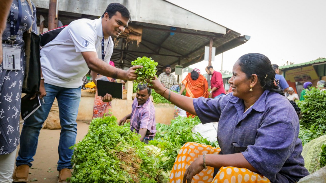 Tanvir Ahmed buys cilantro at India market
