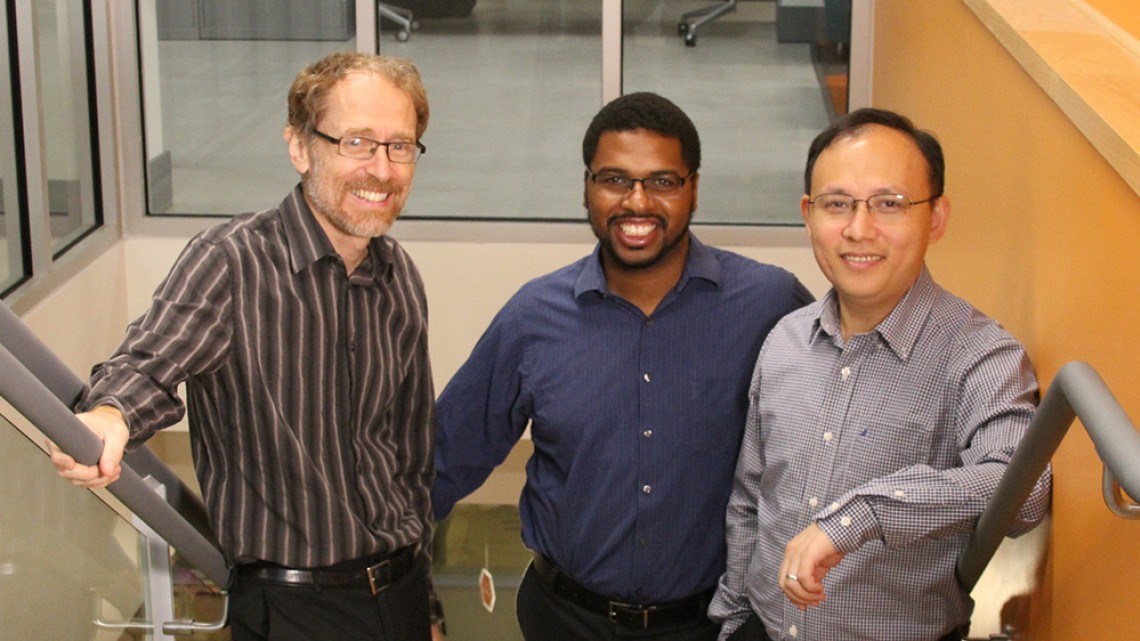 Robbert van Renesse, Hakim Weatherspoon, and Zhiming Shen, co-founders of Exotanium, pose on a stairway.