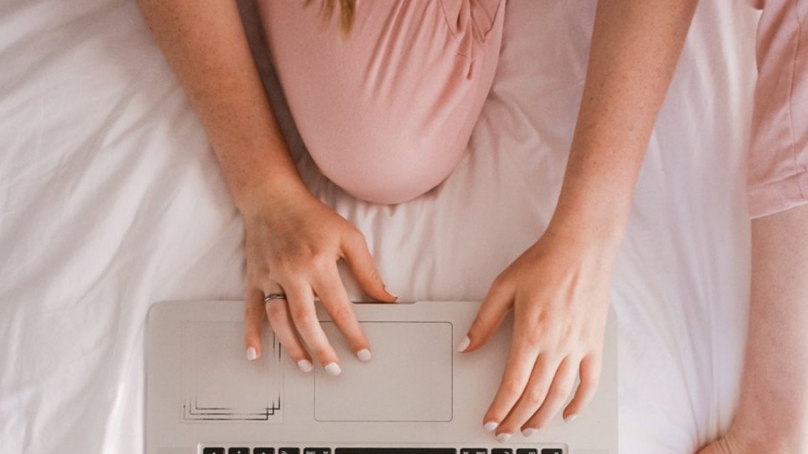person on laptop in pajamas