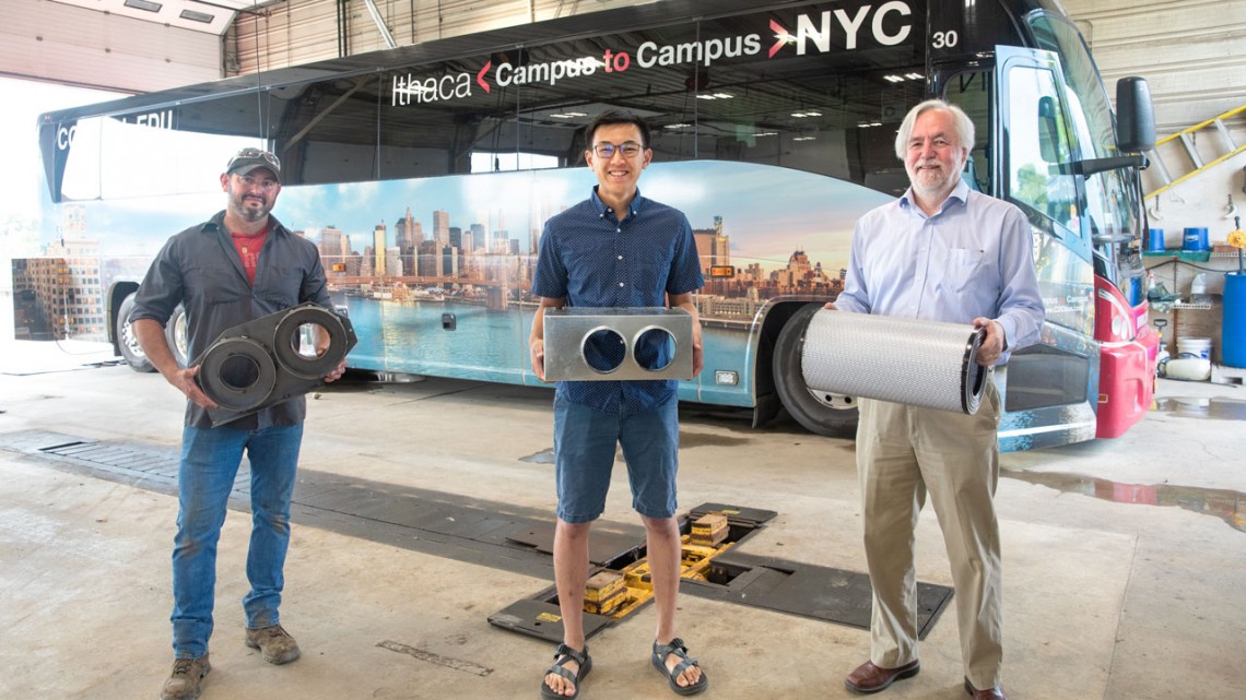 From left, William Meade, the lead mechanic and fleet manager with Transportation and Delivery Services, Christopher Kartawira and Mark Hurwitz hold components of the air filtration system that has enabled the C2C buses to resume service.