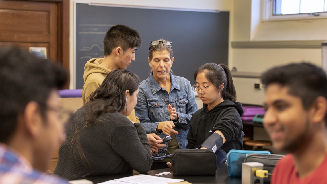 Darlene Campbell, senior lecturer in biology, works with students in a classroom.