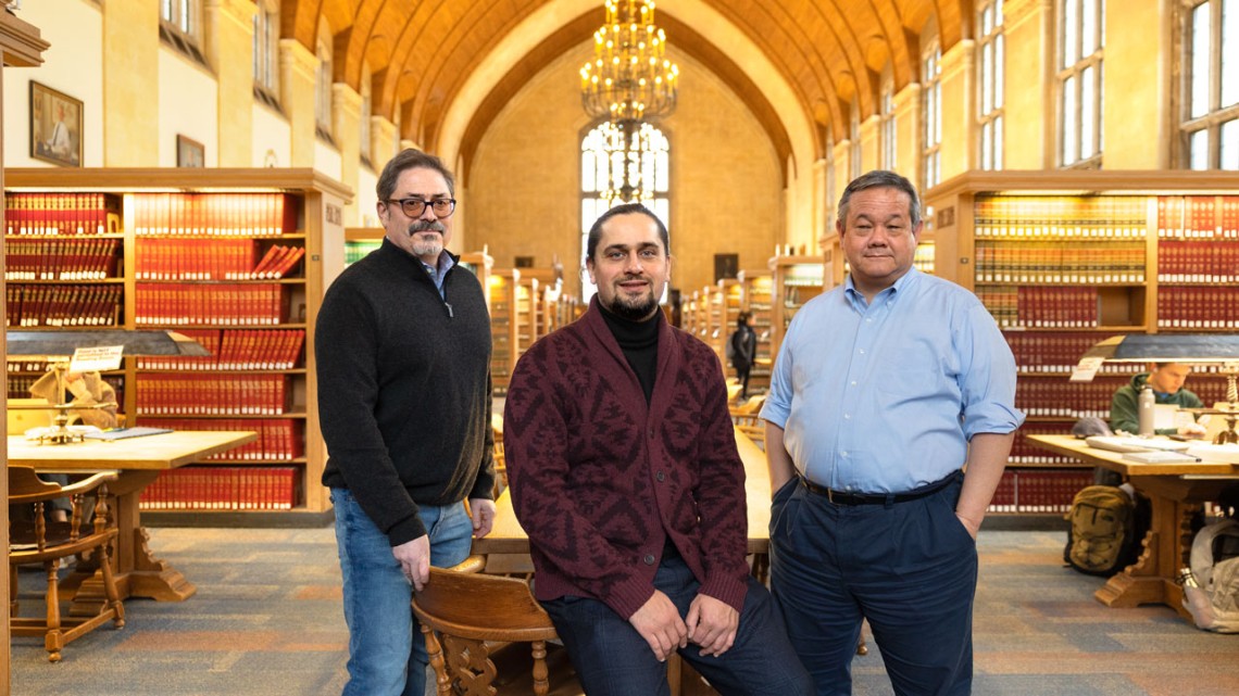 From left, Felix Litvinsky, managing director of Cornell’s Blackstone LaunchPad; Ukrainian entrepreneur Daniel Matsui; and Charles Whitehead, the Myron C. Taylor Alumni Professor of Business Law, in the library of Myron Taylor Hall.