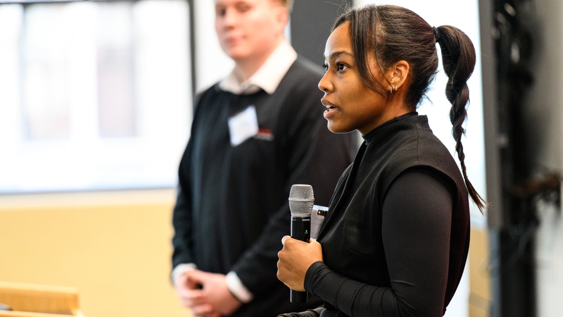 Doctoral student Faith Carter pitches her startup to an audience.