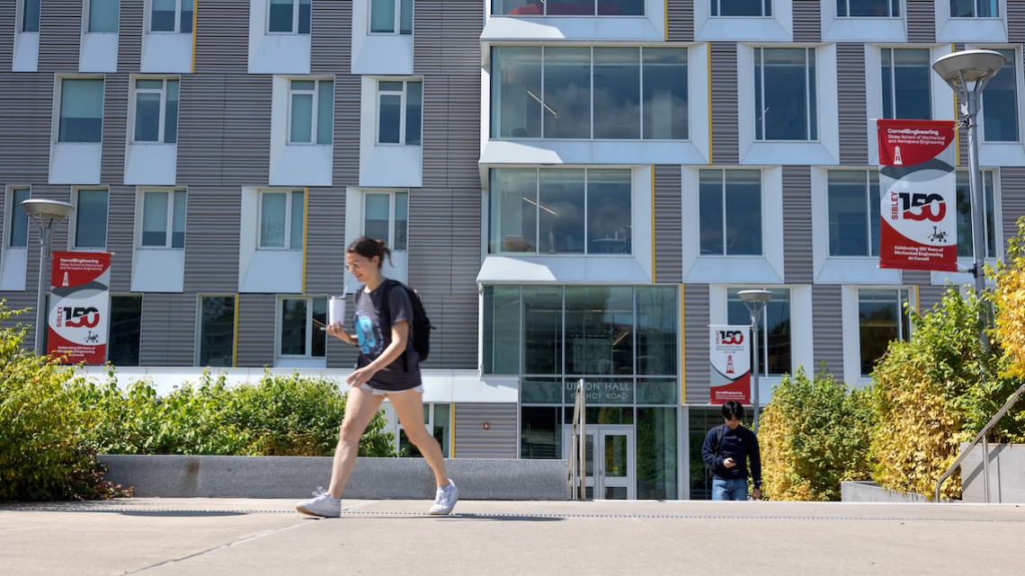 student walks in front of Upson Hall
