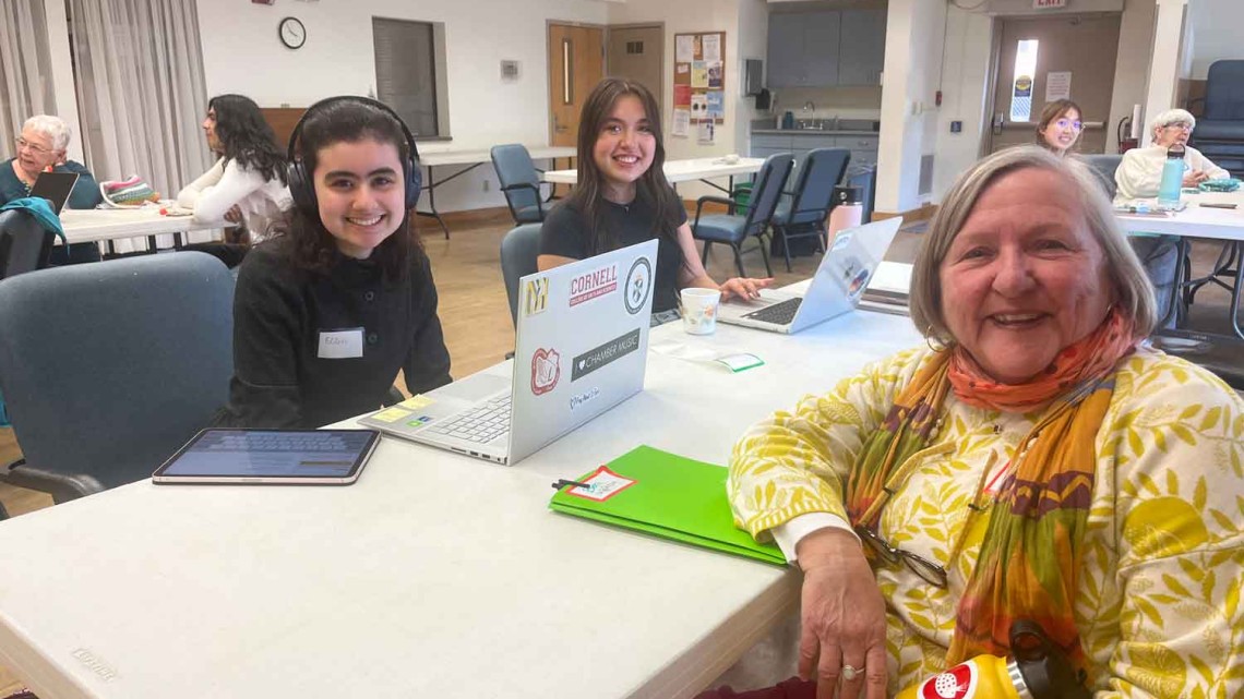 people sitting at a table smiling