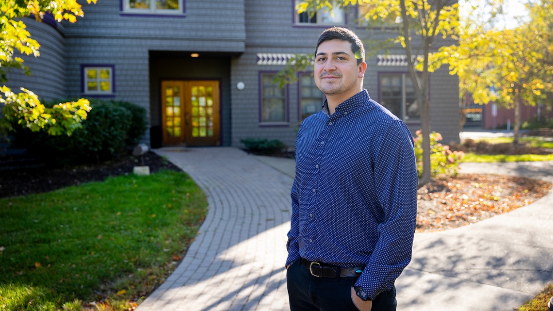 Michael Charles ’16, a citizen of the Navajo Nation and assistant professor, outside Akwe:kon, a residence hall devoted to Indigenous cultures, where Charles lived as an undergraduate at Cornell.