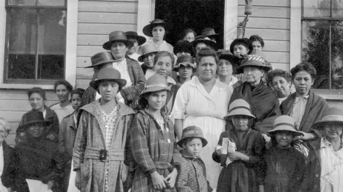 Members of the Onondaga Conservation Club standing in front of Temperance Hall on the Onondaga Nation, circa 1919.