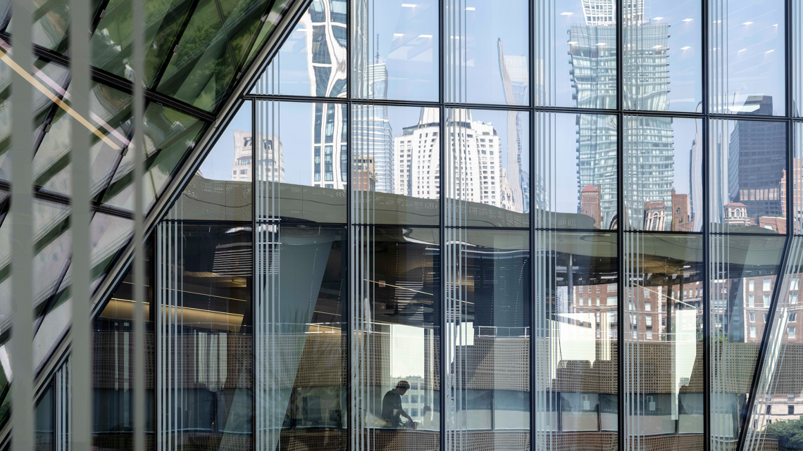 NYC skyline reflected by glass building
