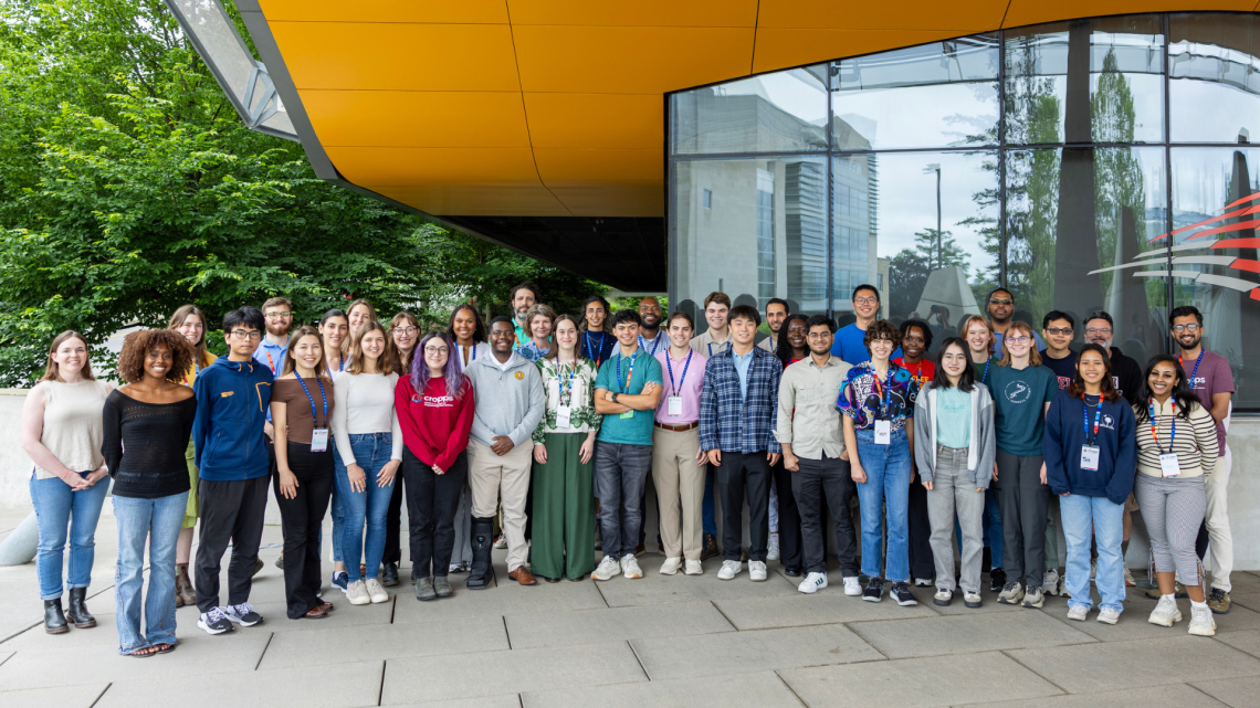 The extended CROPPS REU team standing in front of building.
