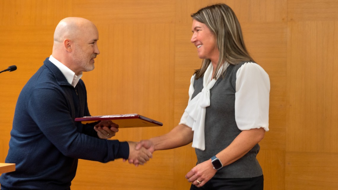 Adrienne Mason, right, administrative director for two departments in the College of Agriculture and Life Sciences, receives the Employee Assembly’s Award for Staff Integrity and Inclusion from Sean Moeller, associate vice president of academic human resources.