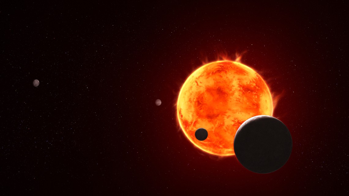 The Earth-size exoplanet TRAPPIST-1 e, depicted at the lower right, is silhouetted as it passes in front of its flaring host star in this artist’s concept of the TRAPPIST-1 system.