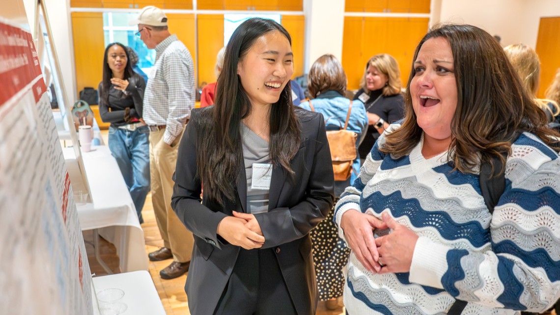 Cornell Cooperative Extension Summer Intern Sophia Li May '28 (left) describes her summer project at a reception Sept. 9
