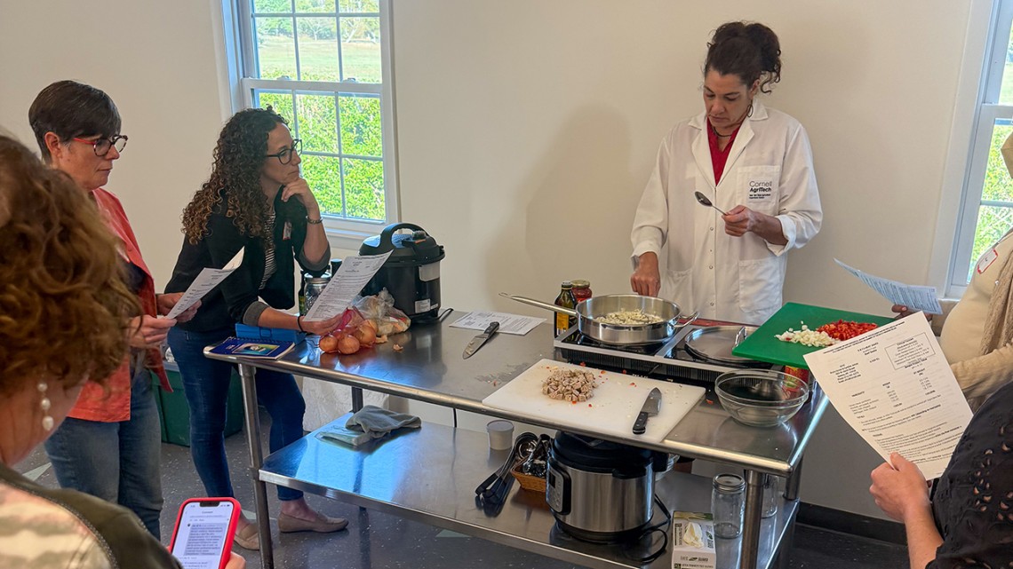 Extension support specialist Cynthia James leads a cooking demonstration at a workshop held at Stony Brook University.