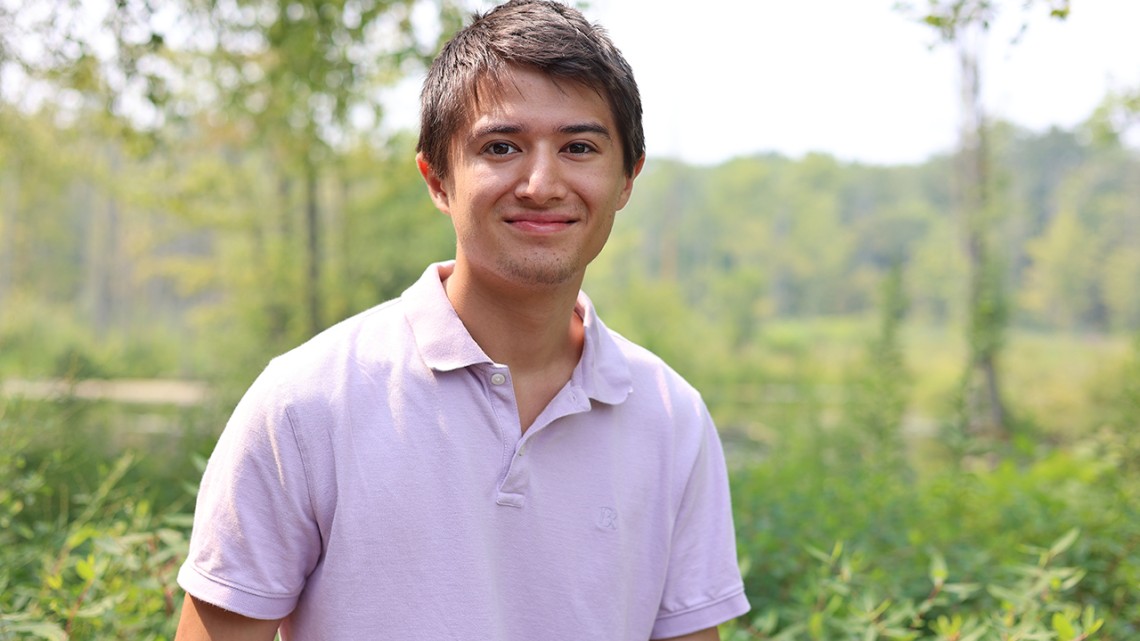Everett Smith ’27 standing in the Sapsucker Woods Sanctuary