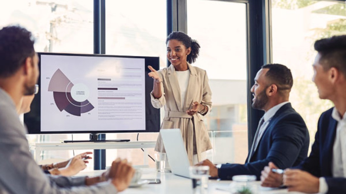 Business meeting presentation with a woman presenting to her colleagues
