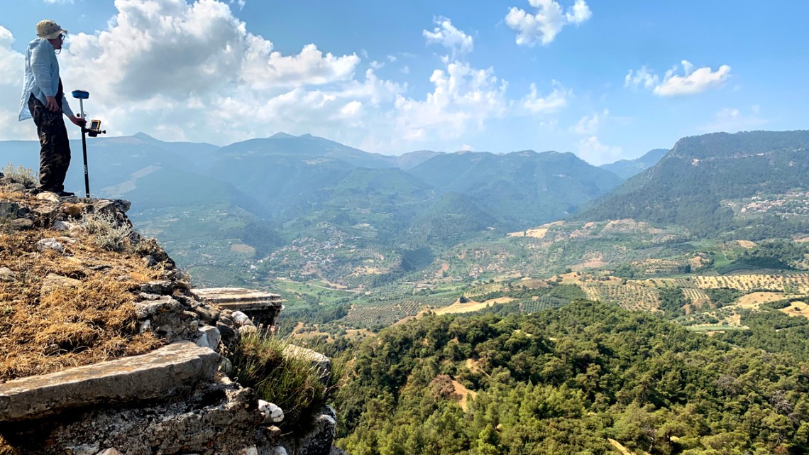 Benjamin Anderson, associate professor of history of art and visual studies, surveys the walls on the acropolis in Sardis, Turkey.