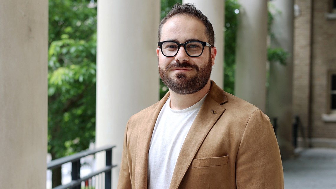 Benny Goldman stands on the portico of Bailey Hall